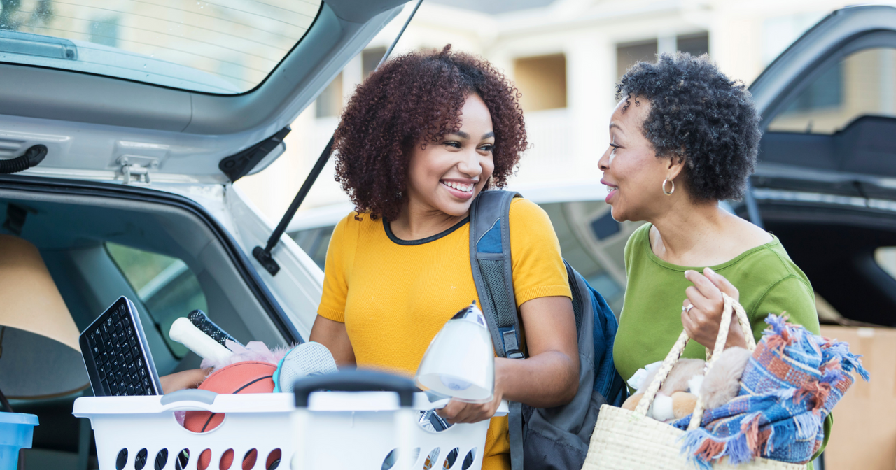 A mother helps her daughter pack the car to go to college