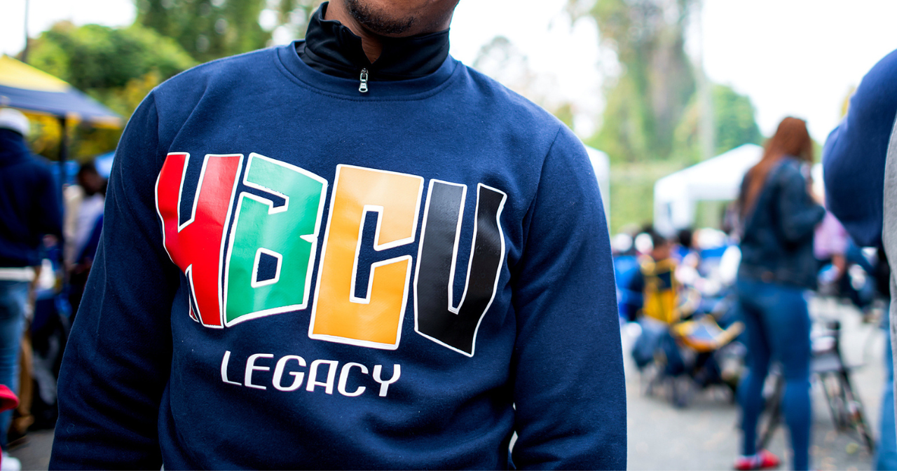 A close up image of a man in a blue sweatshirt with the words "HBCU Legacy."