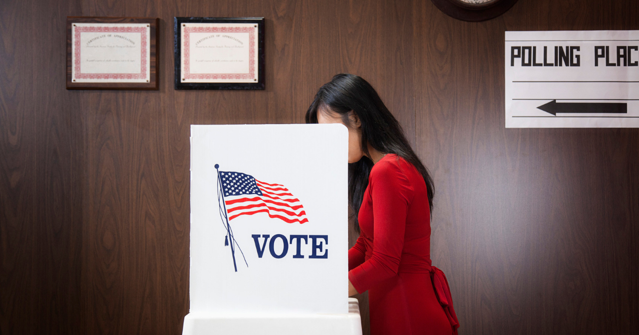 A woman voting in a booth