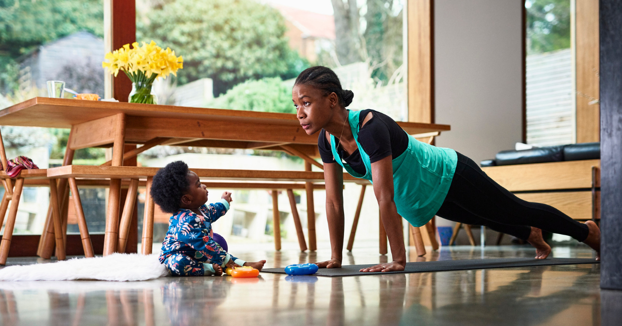 A black woman does yoga with her son watching