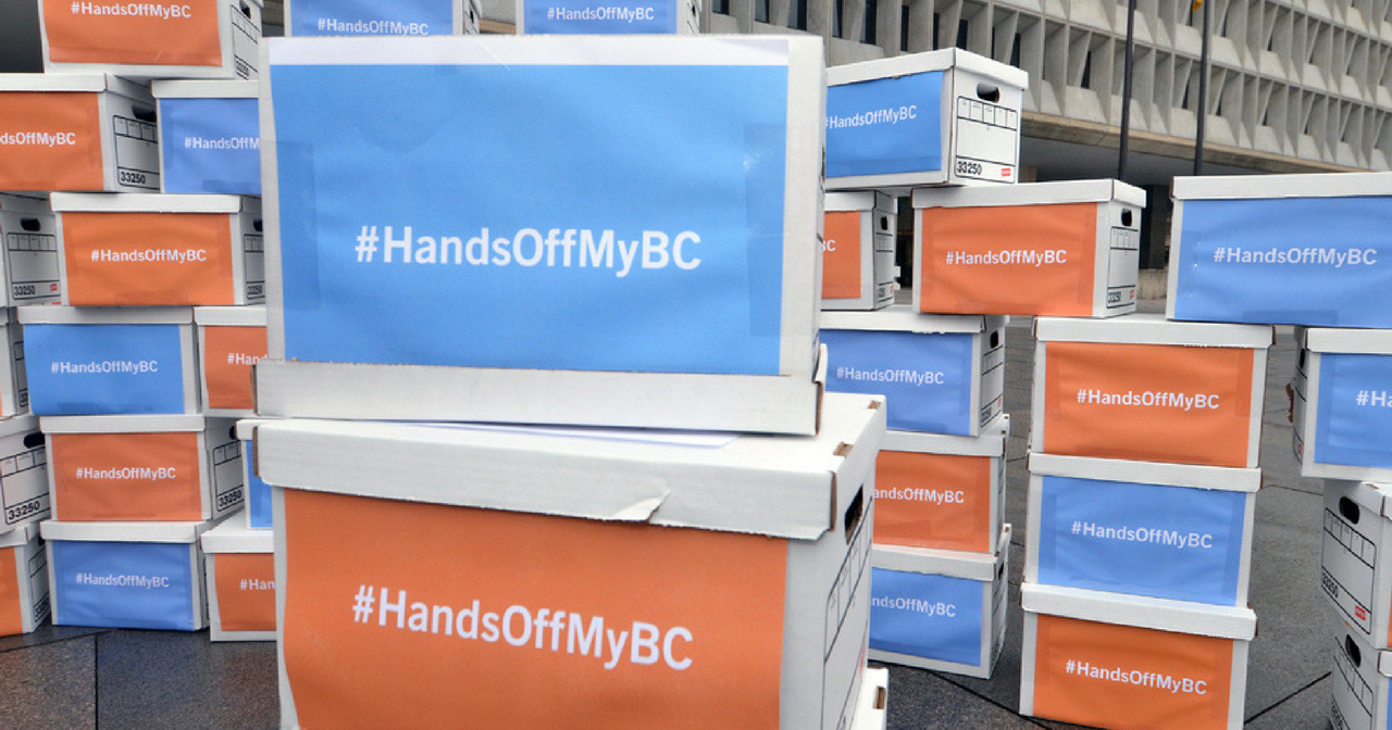 boxes with signs that read, "Hands Off My BC"