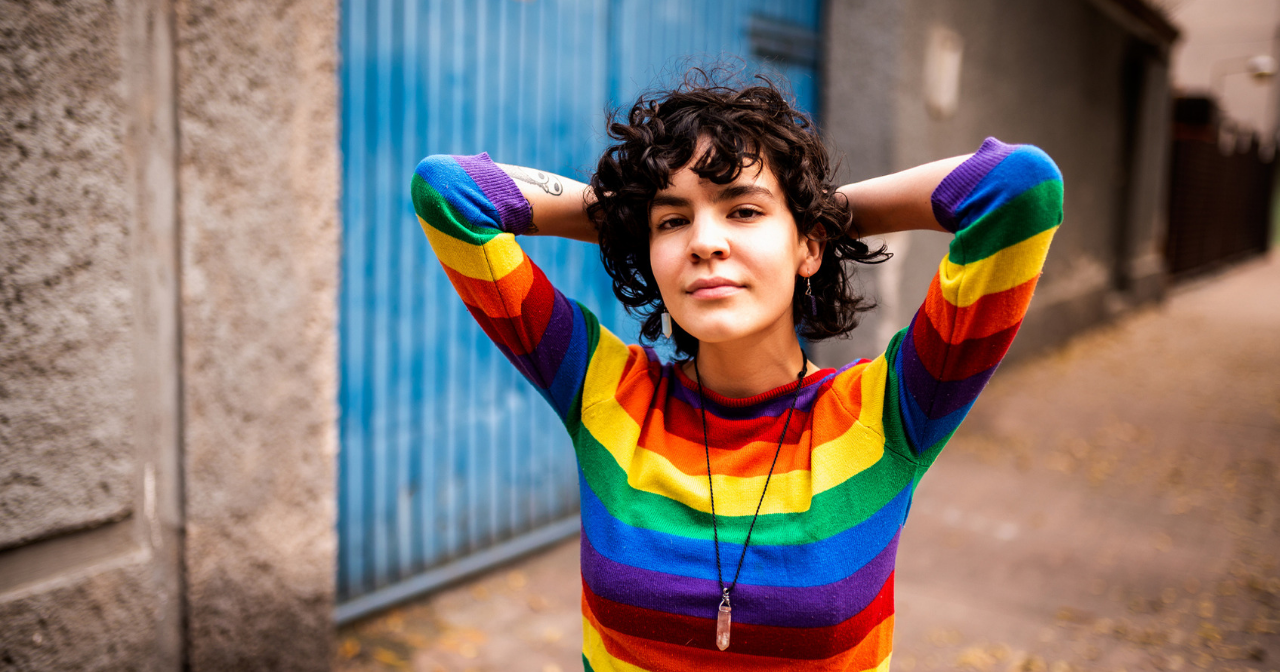 A woman in a rainbow shirt