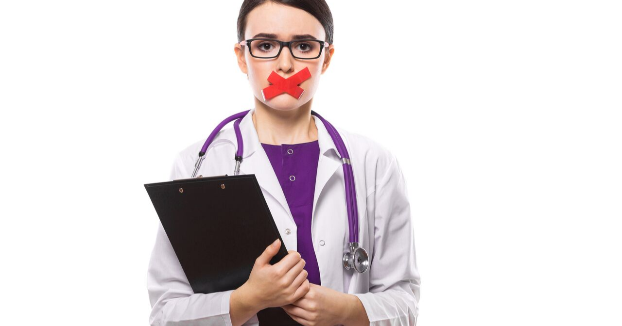 a doctor with tape over her mouth preventing her from speaking