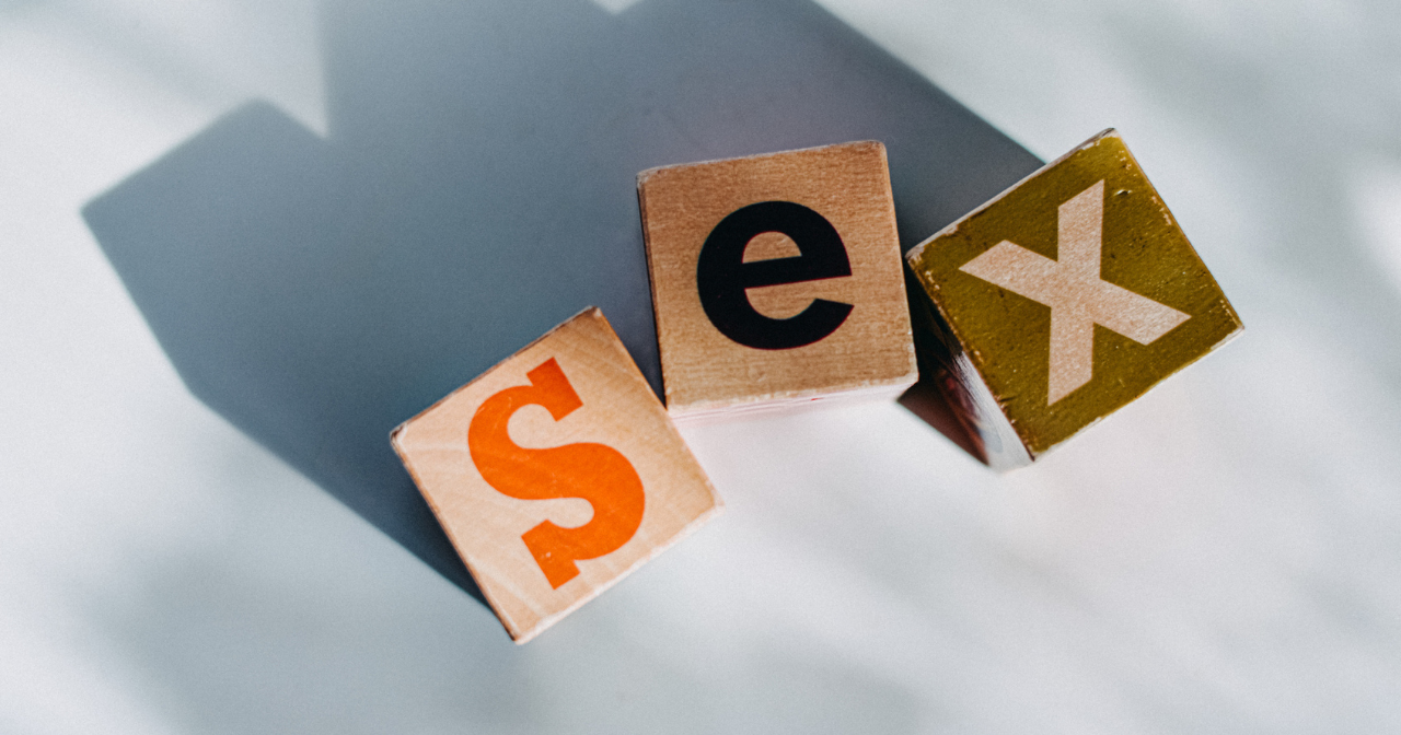 Three wooden blocks with letters on them spell out sex. 