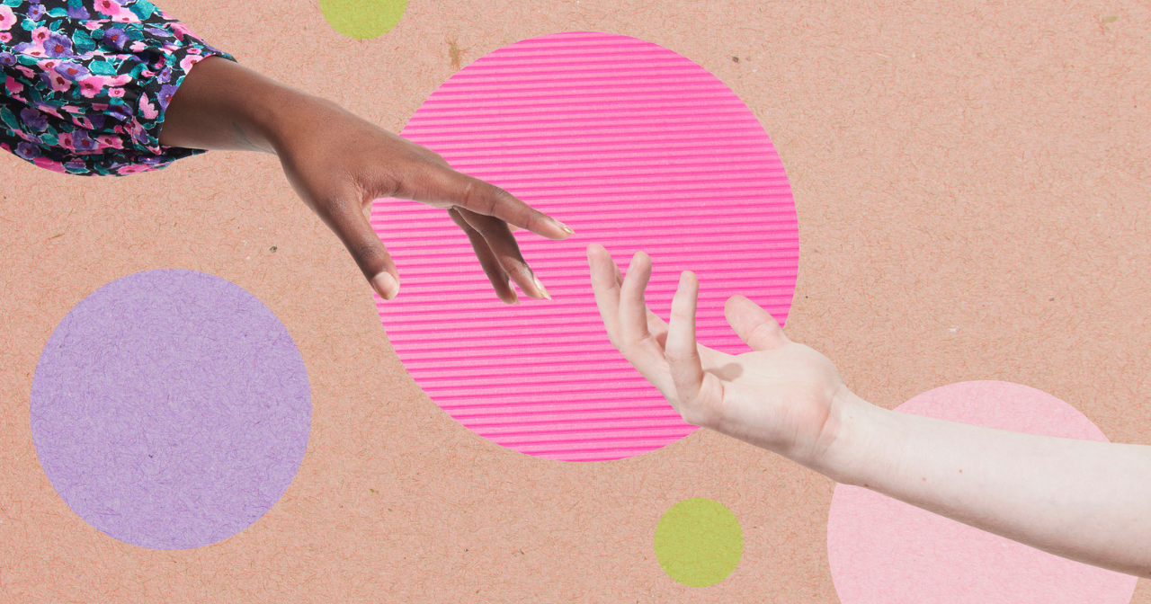 Two hands reach out to another another in front of a polka dotted background. 