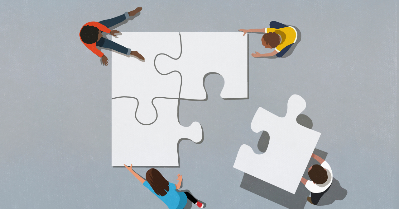 An illustration of four people with human sized puzzle pieces working together to put them together. 