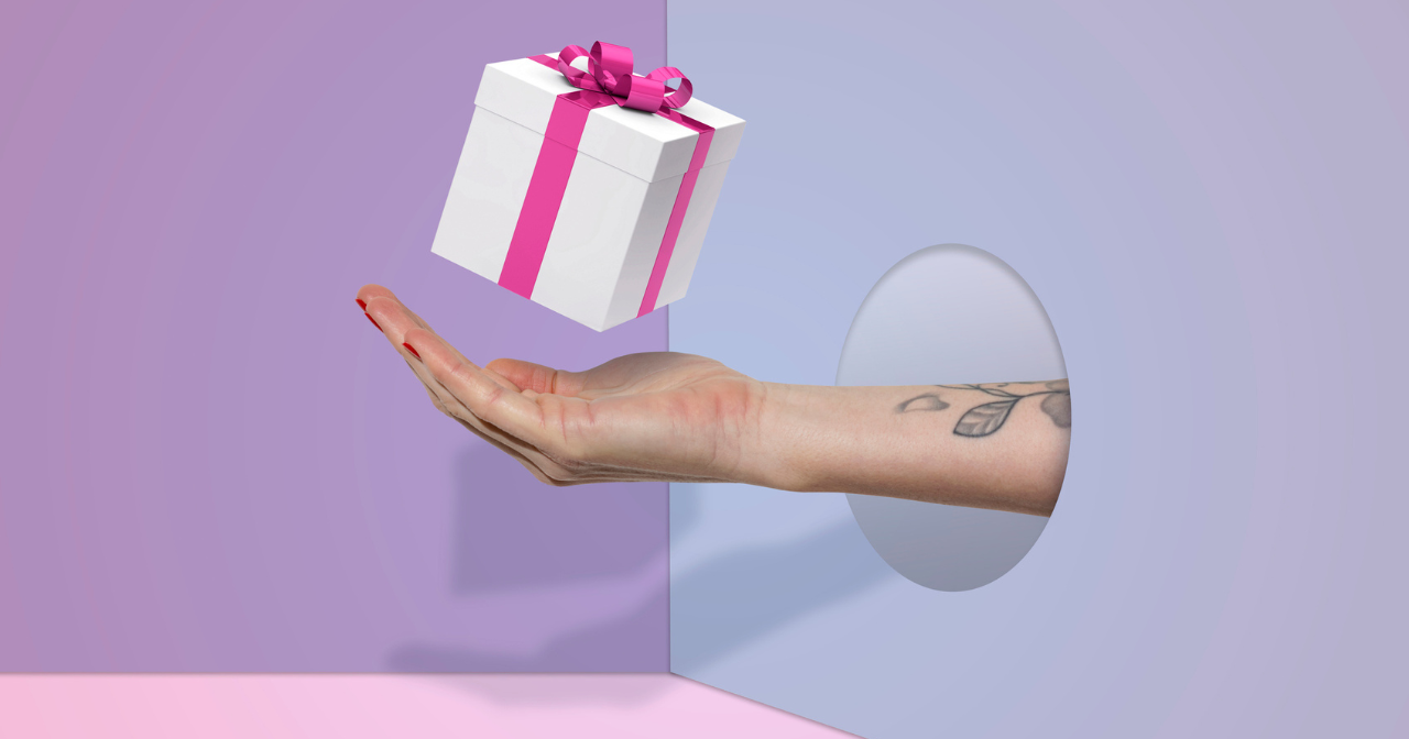 A hand with a present hovering above it.