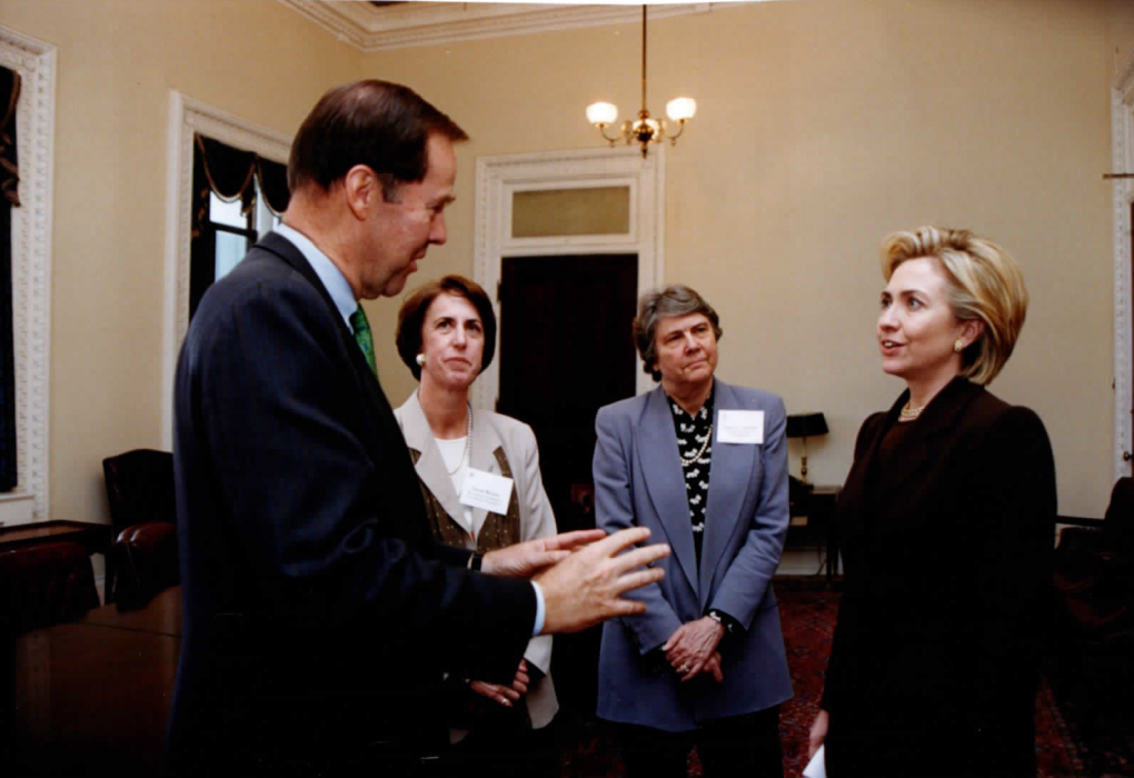 A photo of Hillary Clinton, Belle Sawhill, and others speaking together. 