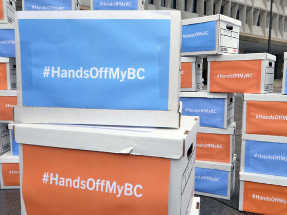 boxes with signs that read, "Hands Off My BC"