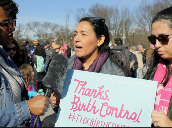 Two women holding a Thanks, Birth Control sign are interviewed
