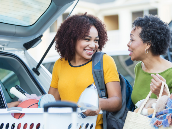 A mother helps her daughter pack the car to go to college
