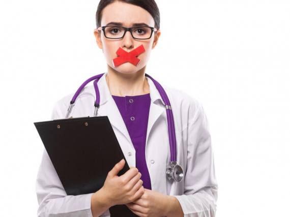a doctor with tape over her mouth preventing her from speaking