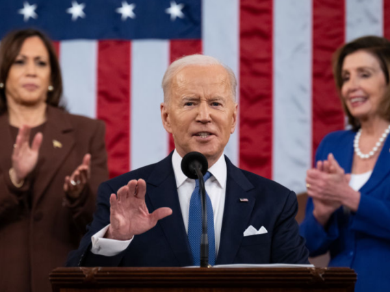President Biden gives his first State of the Union address while VP Harris and Speaker of the House Pelosi stand and clap behind him. 