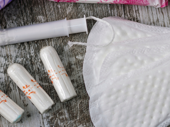A selection of pads and tampons spread across a table.
