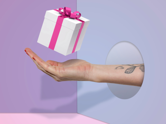 A hand with a present hovering above it.