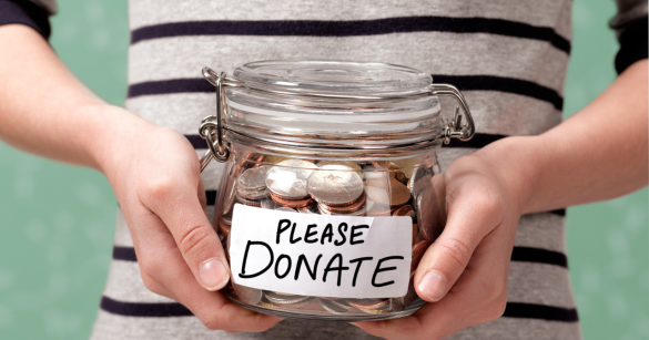 A pair of hands holding a jar filled with change and a label that says, "Please Donate."